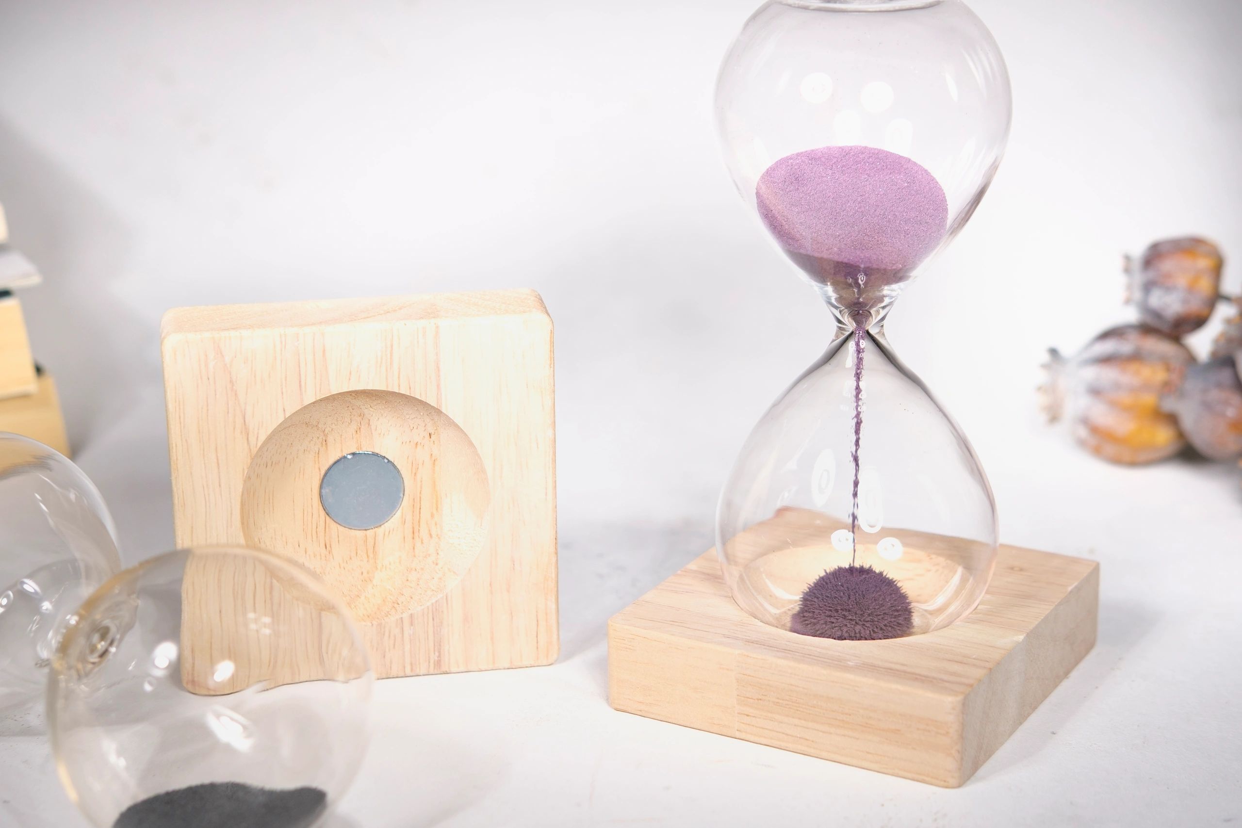 Magnetic sand hourglass product on a clean white background